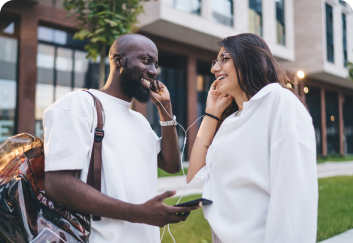 Two people outdoors, one on a phone call