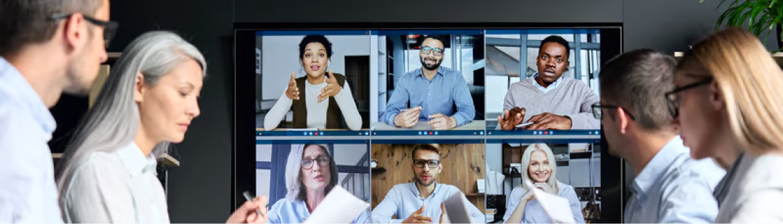 Team reviewing a video call wall display